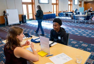 High school student participates in a one-on-one discussion with a facilitator.